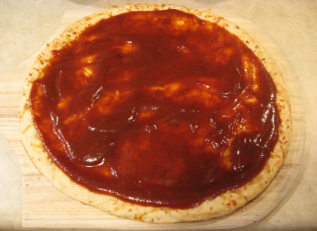 Spread sauce on crust