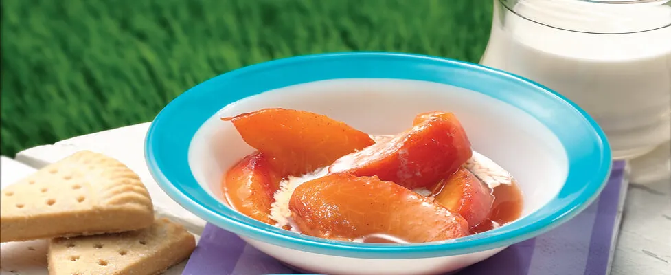 grilled peaches in a bowl