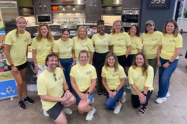 team of people wearing yellow t-shirts in demo kitchen
