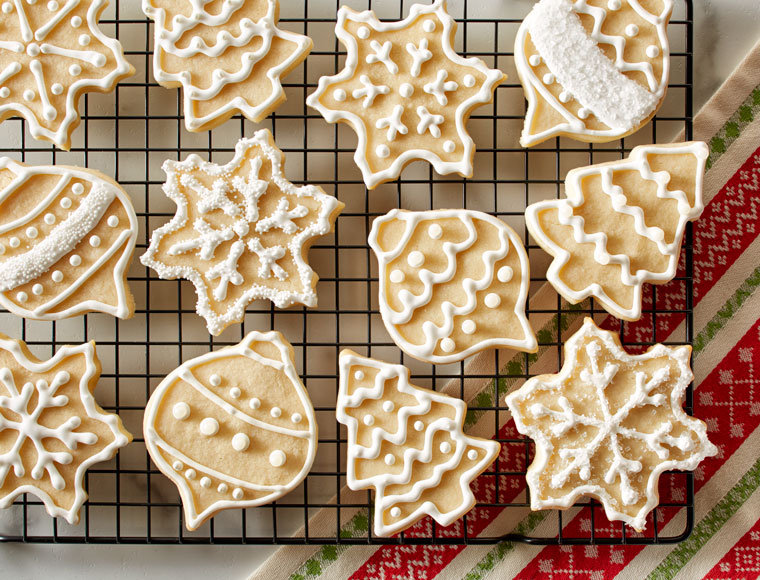 frosted christmas sugar cookies on cooling rack